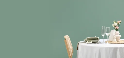Fotobehang Eetkamer Hospitality and fine dining concept, elegant table setting with flowers and wine glasses in a minimalist restaurant interior with sage green wall  © Pixel-Shot