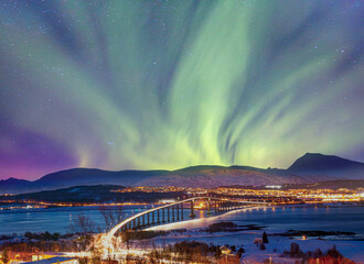 Aurora borealis or Northern lights in the sky over Tromso with Sandnessundet Bridge - Tromso, Norway © muratart