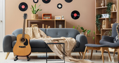 Home comfort and interior design, acoustic guitar in a cozy living room with retro vinyl records...