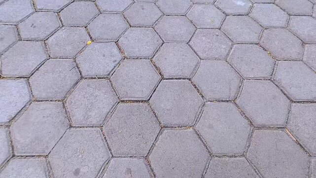 High angle close up shot of grey hexagonal paving block pattern