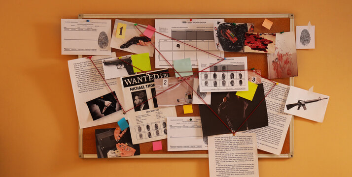 Criminal investigation board with evidence crime scene analysis with red string suspect photos fingerprints and weapons on a cork bulletin board