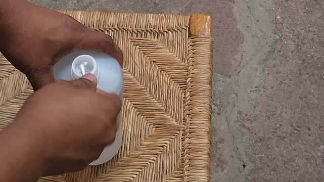 Pouring Isopropyl Alcohol onto Cotton Swab for Delicate Surface Cleaning