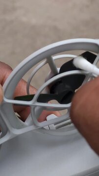 Close Up of Cleaning Drone Propeller Guard with Cotton Swab
