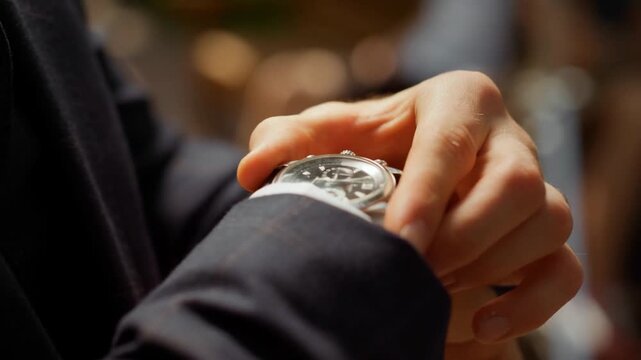 Man Adjusting Watch and Getting Dressed Elegantly, man in suit fastens wristwatch while preparing for formal event. confident outdoors checking time on wrist hour. Professional businessman. meet late