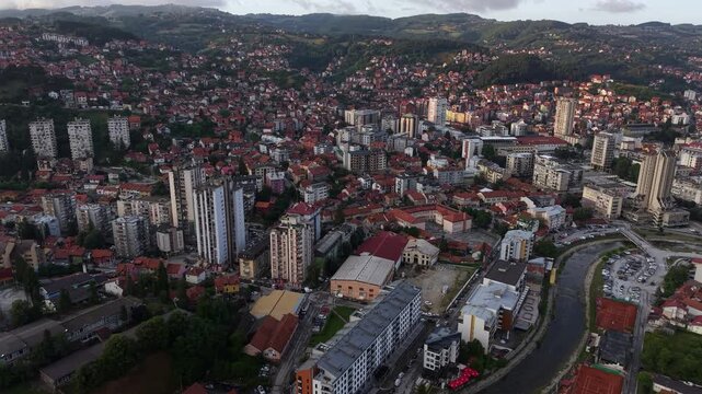 Drone Shot of Uzice Serbia at Sunset, City Downtown Buildings and River