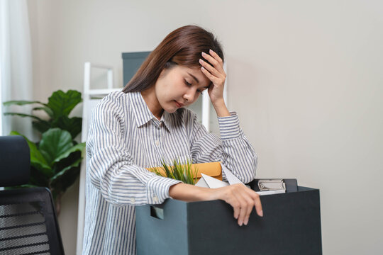 Resigned from work. female employee packing stuff to leave the job