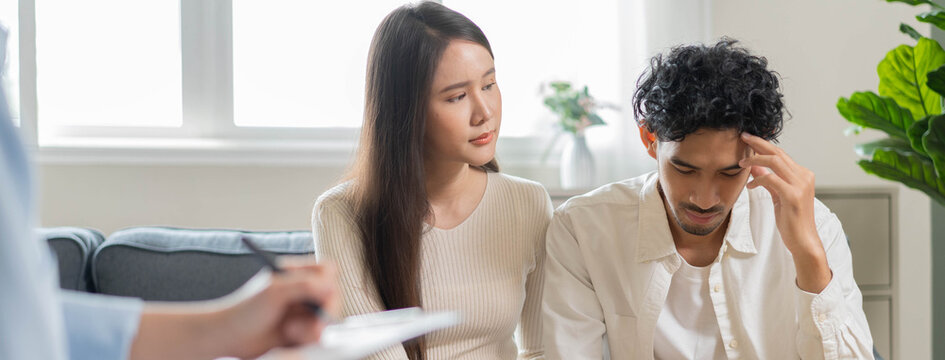 Spouses relationship consultant concept, Close-up hands of psychologist holding pen and note during therapy talk session for married couple that mental health breakdown and relationship problems.