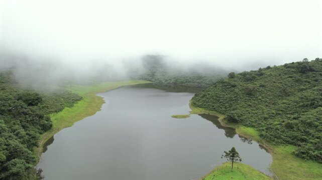 4K drone aerial view of Yala Provincial Park in Jujuy, Argentina. Misty mountain lakes surrounded by lush Yungas forests and dense green vegetation in a spectacular Andean landscape.