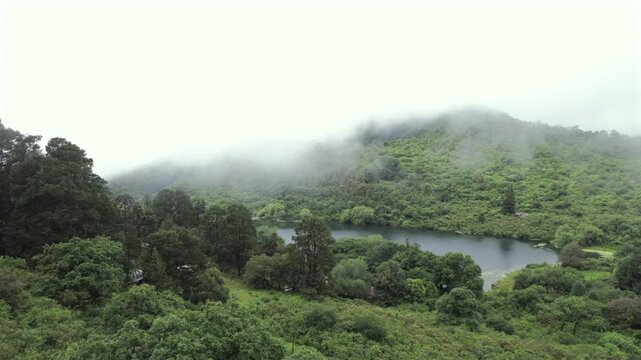 4K drone aerial view of Yala Provincial Park in Jujuy, Argentina. Misty mountain lakes surrounded by lush Yungas forests and dense green vegetation in a spectacular Andean landscape.