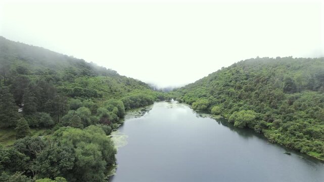 4K drone aerial view of Yala Provincial Park in Jujuy, Argentina. Misty mountain lakes surrounded by lush Yungas forests and dense green vegetation in a spectacular Andean landscape.