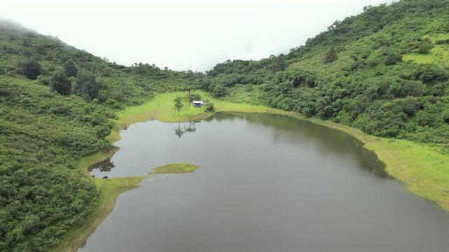 4K drone aerial view of Yala Provincial Park in Jujuy, Argentina. Misty mountain lakes surrounded by lush Yungas forests and dense green vegetation in a spectacular Andean landscape.