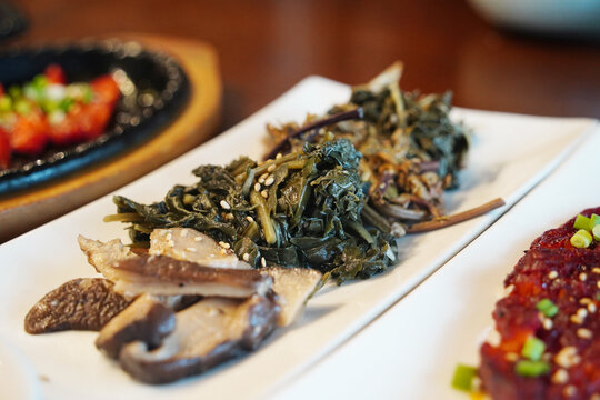 Assorted Korean traditional seasoned vegetables and mushrooms banchan served elegantly on a plate, healthy vegan food side-dishes