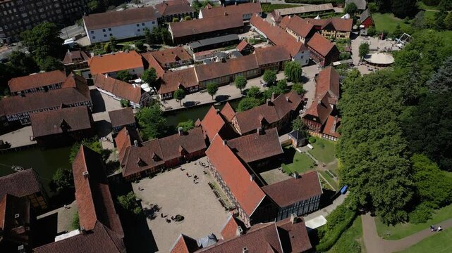 Den Gamle By historic buildings and courtyards surrounded by trees in Aarhus, Denmark, aerial establishing overview
