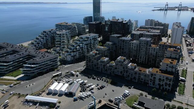 Modern apartment blocks beside the waterfront in Aarhus docklands district, Denmark on a clear day, aerial medium orbit