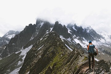 Fototapeta premium Backpacker hiking up Chamonix Alps in France border background