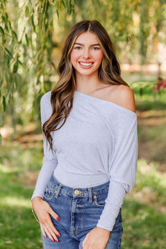 Beautiful young woman smiling outside in nature