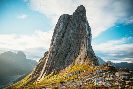 Hiker on scenic trail viewing Segla mountain Norway