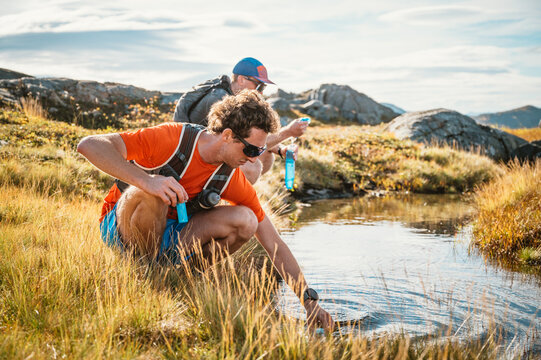 Men getting fresh water during a mountain run