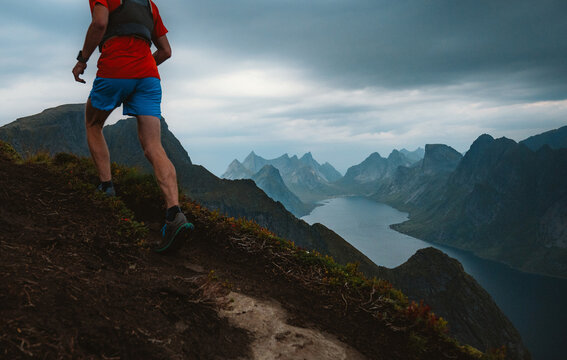 Man trail running up a steep mountain incline