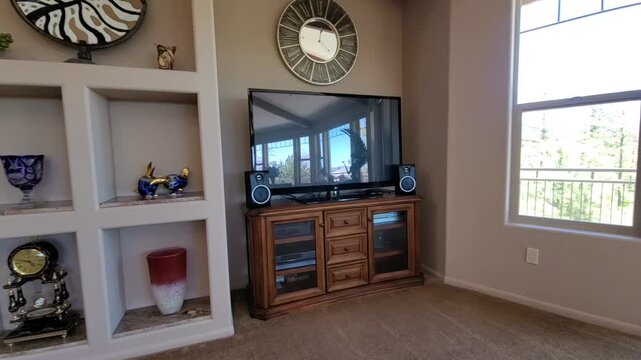Cozy living room with wooden media shelf and round clock