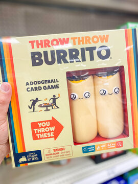 A person holding a box of Throw Throw Burrito dodgeball card game on a store shelf - Auburn WA USA - August,21 2026