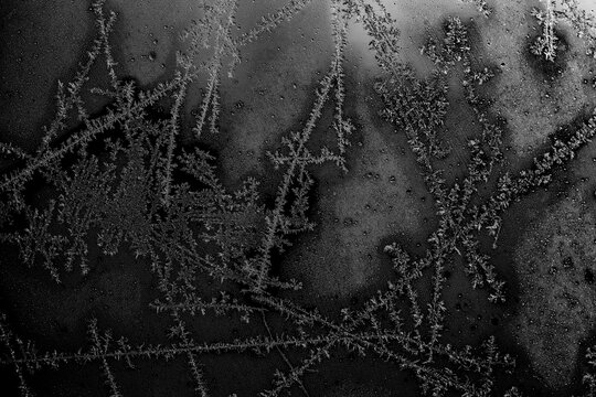 Christmas frost and ice crystals on frozen glass.