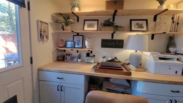 Cozy kitchen-integrated home workspace with plants and shelves