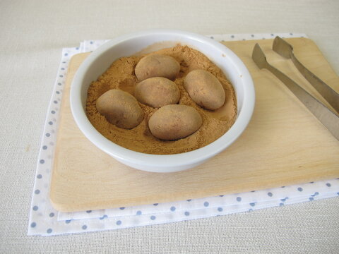 Homemade marzipan potatoes or marzipan eggs with low-histamine carob powder as a substitute for cocoa
