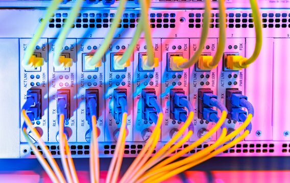 Fiber Optic cables connected to an optic ports and Network cables connected to ethernet ports and UTP Network
