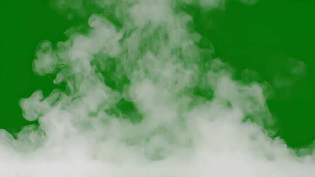 Ethereal wisps of smoke drift across a chroma key green background with cinematic motion during a subtle camera pan