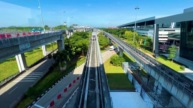 High Angle View of Modern Airport Monorail Sky Train Track and Highway Flyover Bridge Modern Public Transportation Network and Infrastructure Concept Connecting Airport Terminals Daytime Footage