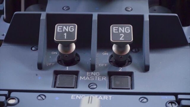 Close up of aircraft engine master switches and engine start rotary selector on center pedestal in flight deck stock video footage