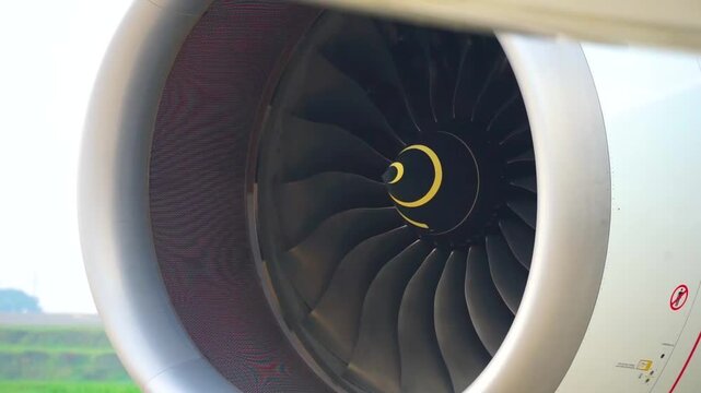 Close up side view of passenger airplane turbofan jet engine with wing preflight ground maintenance at airport runway aerospace technology background stock footage