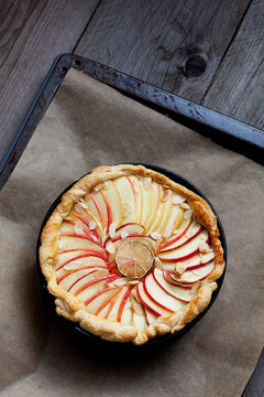 Baked apple pie in cake pan on baking tray