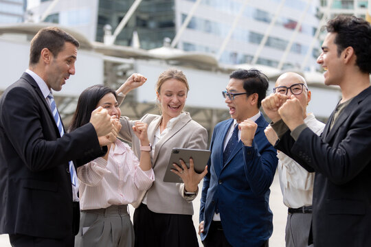 Business success concept, Colleagues cheering and celebrating teamwork achievement outdoors in corporate area. success, teamwork, business, celebration, achievement.