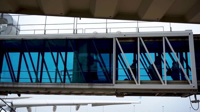 Airport Boarding Bridge Glass Jetway Walkway Passengers Boarding Aircraft Aviation Travel Transport Stock Video Footage