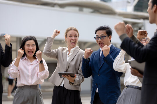 Business success concept, Colleagues cheering and celebrating teamwork achievement outdoors in corporate area. success, teamwork, business, celebration, achievement.