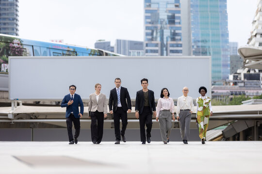 Business leadership concept. Diverse team walking confidently together through an urban corporate district. leadership, business, teamwork, diversity, confidence.