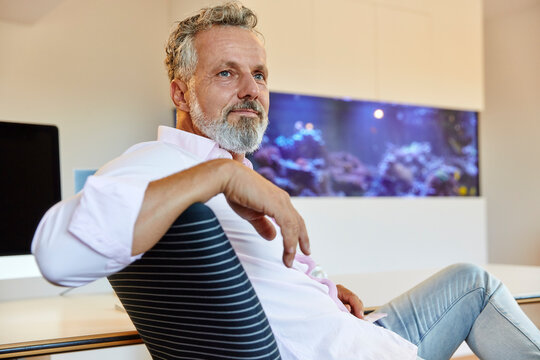 Businessman sitting in office thinking