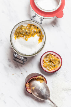 Bowl of vegan coconut yogurt with passion fruit pulp