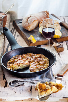 Potato tortilla in pan, port wine and bread