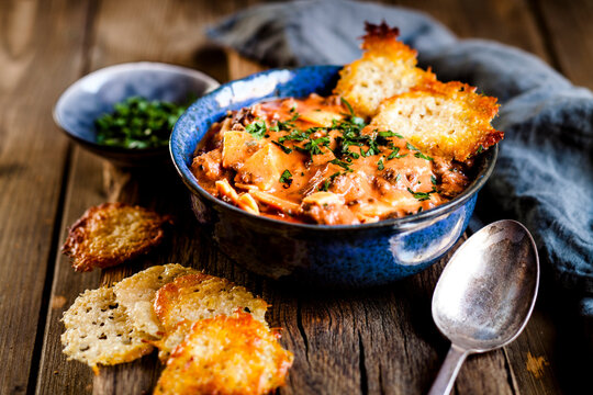 Lasagna soup, deconstructed lasagna served as soup, with parmesan crisps