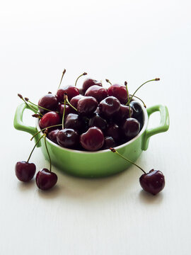 Portion of fresh ripe sweet cherries served in bowl, natural organic cherry berries, summer fruit