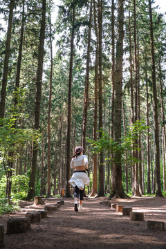 A woman runs an obstacle course during a fun forest workout