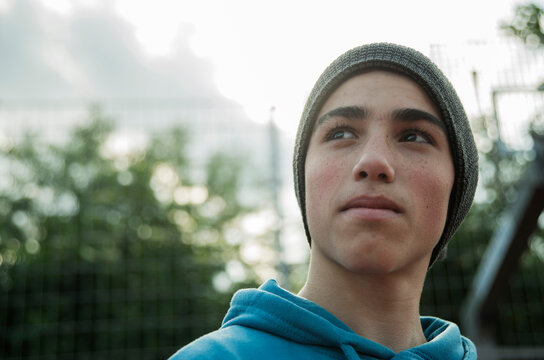 Serious boy wearing beanie outdoors