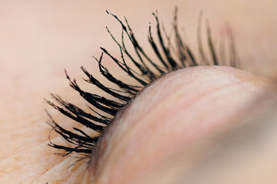 Close-up of a human eye with long, dark lashes
