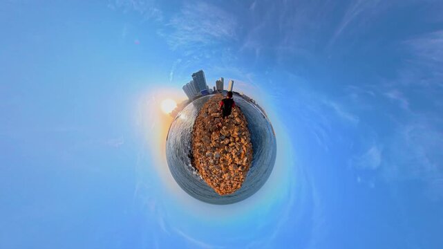 Person walking on a rocky pier in cartagena tiny planet view