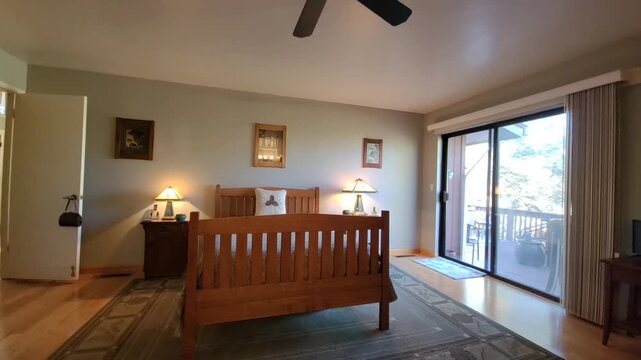 Bright hotel-style bedroom with king bed and sliding glass door