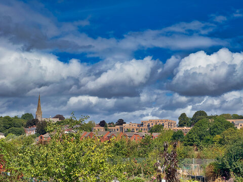 Exeter City Skyline View with Church Spire and Dramatic Blue Sky