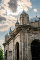 Naklejka premium Aziziye Mosque facade and domes under dramatic Konya sky